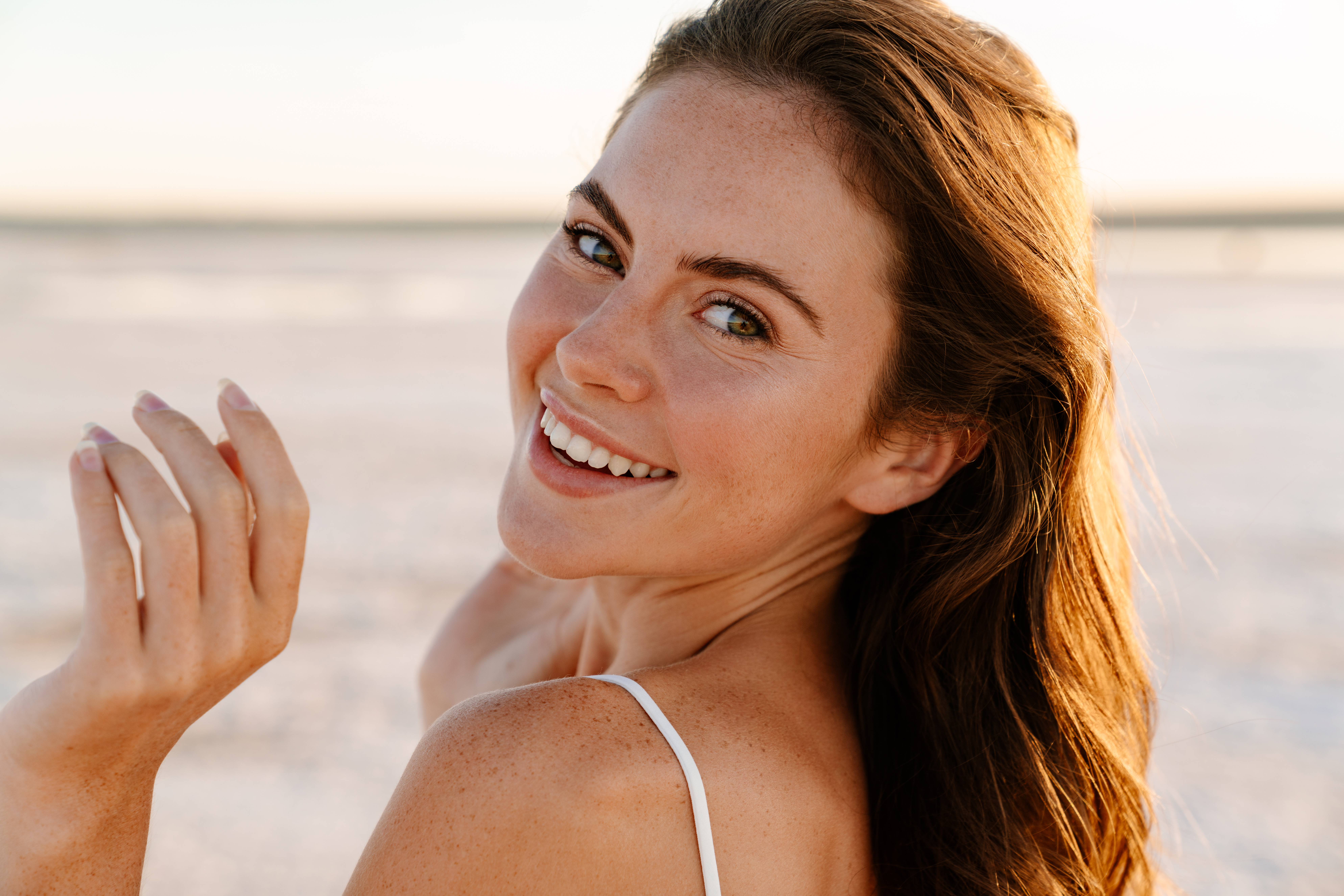 Young girl smiling on the beach